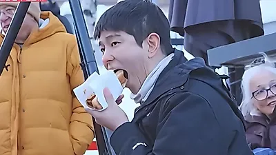Yoo Hae Jin savors reindeer hot dogs beside a Norway campfire