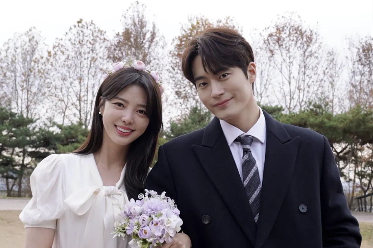 Actress Um Hyeon-gyeong Smiling While Walking Along a Flower Path