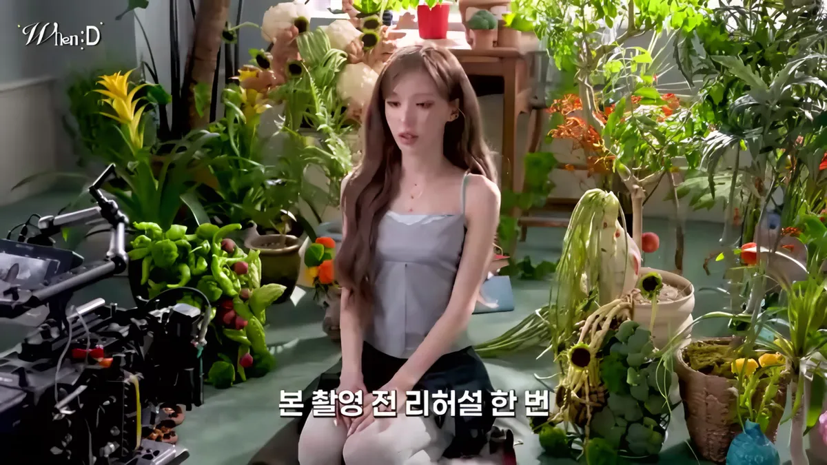 Wendy sits with her pet dog Baekseol on her lap at the 'Your Lips' shoot decorated with plants