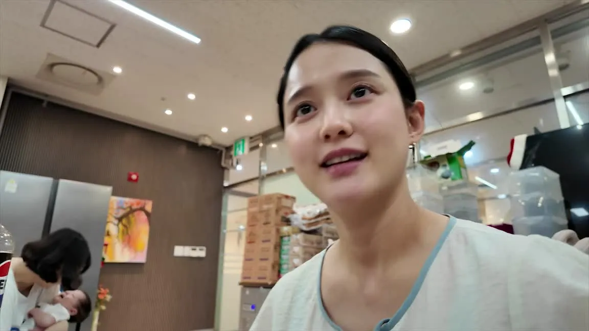 Nam Bo-ra talks to the camera while caring for her newborn — YouTube: Nam Bo-ra's Life Theater