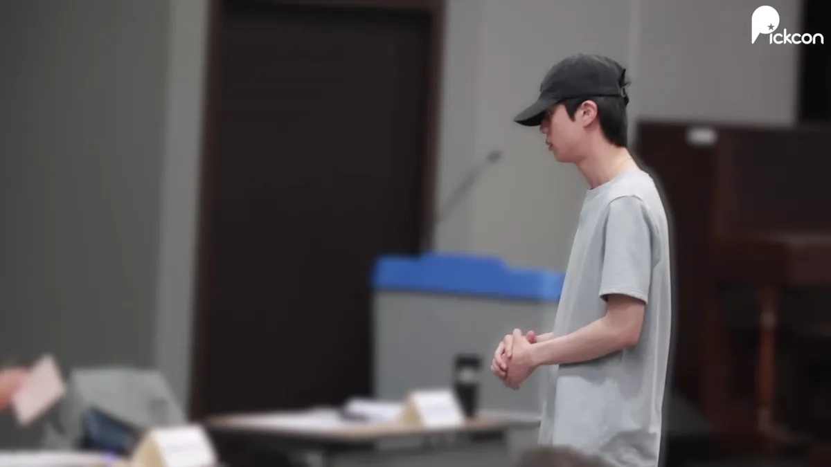 BTS Jin at a Polling Station in a Grey Top and Black Cap